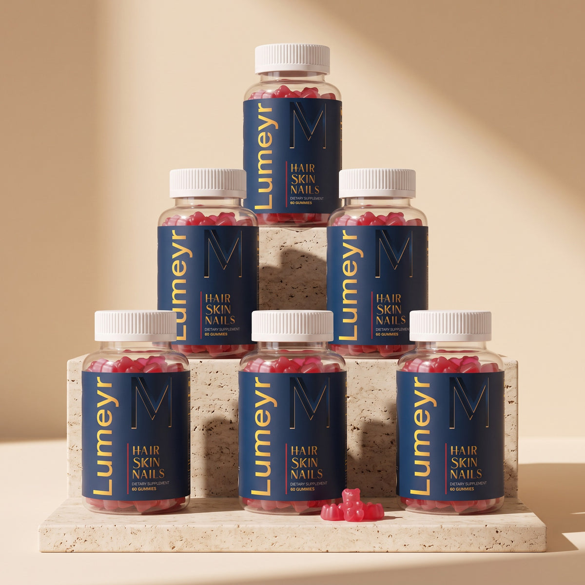 Six bottles of Lumeyr Hair Skin Nails gummies stacked in a pyramid on travertine slabs - 6-month supply